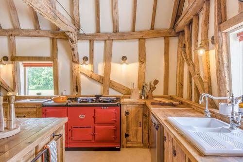a kitchen with wooden counters and a red cabinet at 6 Bed in Ardleigh oc-b35089 in Ardleigh