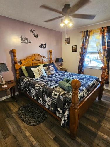 a bedroom with a large bed with a wooden frame at Rowan's Mountain View in Powell