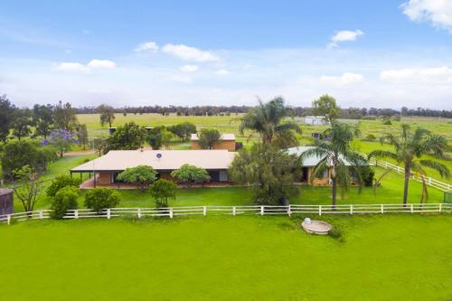 an aerial view of a house in a green field at Hunter Valley 2 x Homes Pets Heated Pool in Whittingham