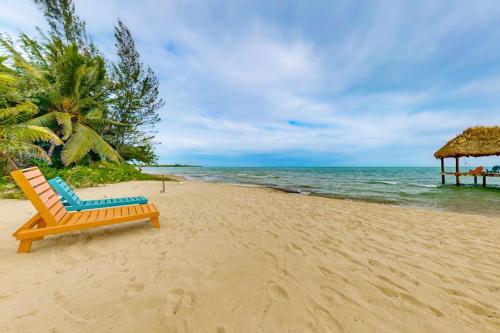 a chair sitting on a beach with the ocean at Ocean Edge Gold Standard Certified in Maya Beach