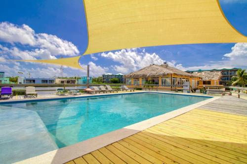 a pool at a resort with a large yellow umbrella at Mara Laguna I301 in San Pedro