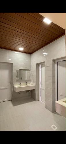 a bathroom with a sink and a mirror at استراحة الروابي in Salalah