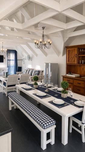 a dining room with a large table and chairs at Be Our Guest Self Catering in Nelspruit