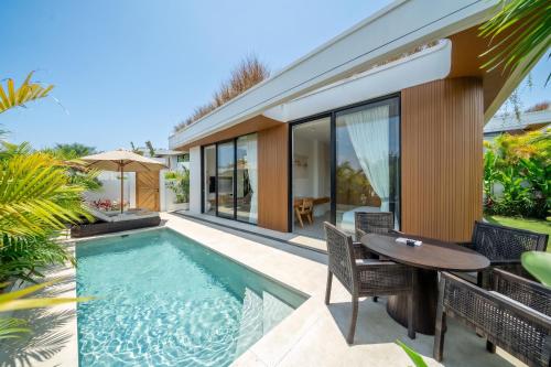 an image of a backyard with a swimming pool and a table at Ardhana Villas - Luxury Pool Stay with Scenic Views in Ungasan