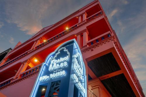 a building with a sign on the side of it at Khaleej Mass Hotel Patong in Patong Beach