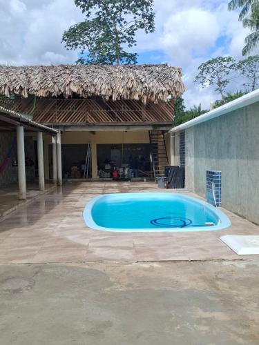 a swimming pool in front of a house at Casa de Praia in Belém