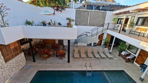 an external view of a house with a swimming pool at Hotel Diamante Sayulita in Sayulita
