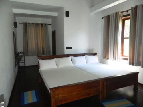 Un pat sau paturi într-o cameră la Birds Paradise Hotel