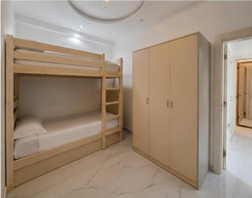 a room with two bunk beds and a closet at Plage & Confort in Fnidek