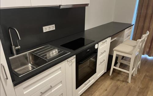 a kitchen with a sink and a stove at Riverside Apartment Tartu in Tartu