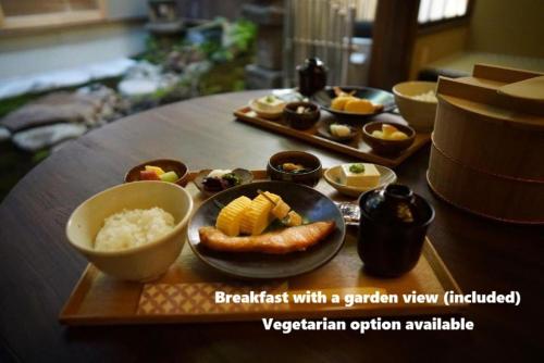 a table with a plate of food on a table at Ryokan Tori in Kyoto