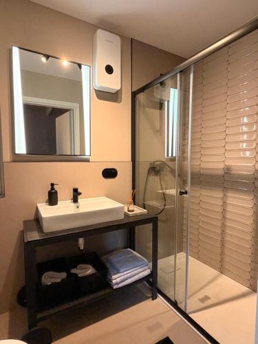 a bathroom with a sink and a shower at Leśna Sonata in Marksoby