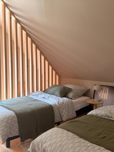 a bedroom with two beds and a window at Leśna Sonata in Marksoby