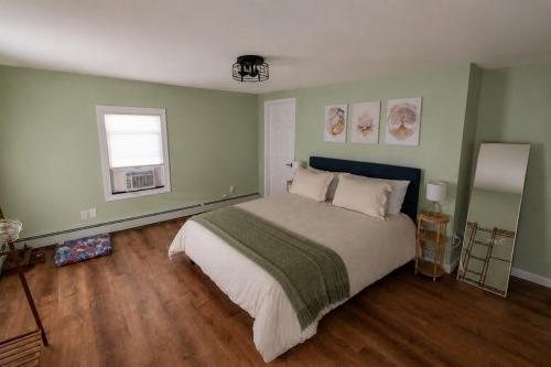 a bedroom with a large bed and a window at Grateful Manor-Close to Downtown- Sauna in Livingston Manor