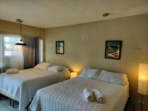 two beds sitting next to each other in a bedroom at Studio in Hallandale 2270 in Hallandale Beach
