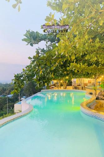 a large blue swimming pool with a sign above it at Castle View Hotel Resort in Samal