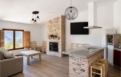 a living room with a stone fireplace and a living room at Los Moreno in Laroya