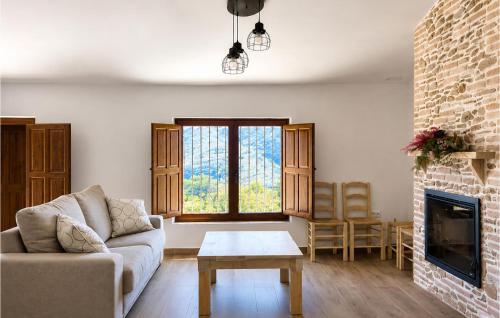 a living room with a couch and a fireplace at Los Moreno in Laroya