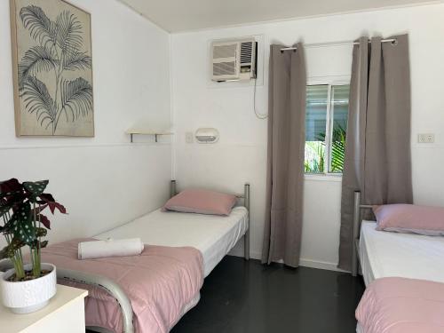 a room with two beds and a window at Kookaburra Holiday Park in Cardwell