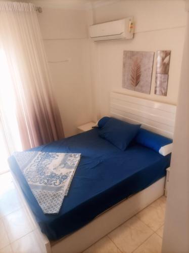a bedroom with a blue bed in a room at Asala Village, Blue Bay Resort, Marsa Matrouh in Marsa Matruh