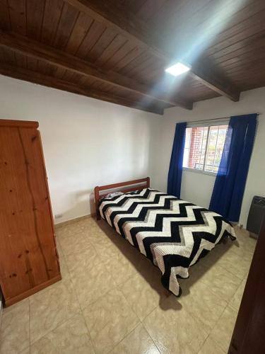 a bedroom with a black and white bed and a window at aura in La Falda