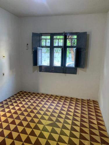 an empty room with a checkered floor and windows at CASA EXPO CRATo in Crato