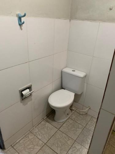 a bathroom with a white toilet in a stall at CASA EXPO CRATo in Crato