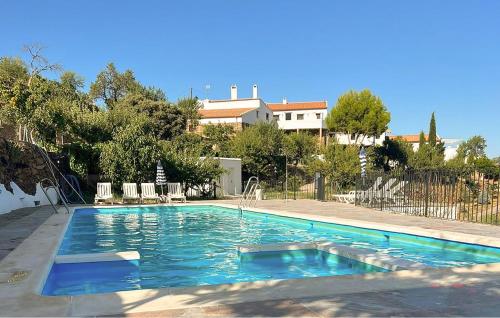 a swimming pool with blue water in a yard at Jaraiz in Laroya