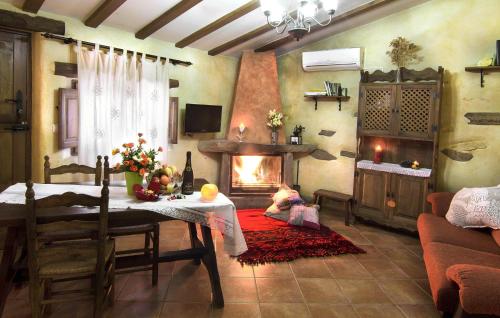 a living room with a table and a fireplace at Jaraiz in Laroya