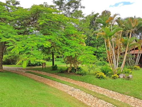 a path in a park with trees and grass at Pousada Kafundó - Inhotim in Brumadinho