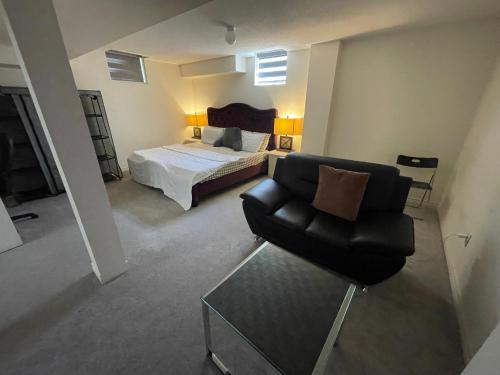 a living room with a chair and a bed at Comfort King in Oshawa
