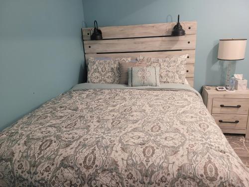 a bedroom with a large bed with a wooden headboard at Blessings Private Home in Louisville