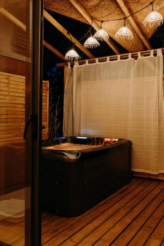 a hot tub on the deck of a house at Domaine S&B in Aubenas