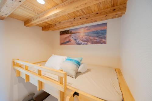 a bed in a room with a wooden ceiling at NEW OPEN! HOTEL Kozafornia in Okinawa City