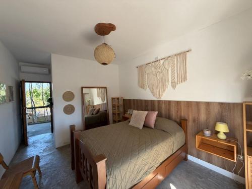 a bedroom with a bed and a table and a mirror at Green Tree El Paredon in El Paredón Buena Vista
