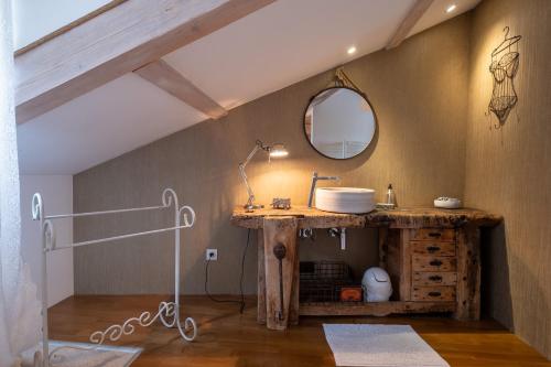 a bathroom with a sink and a mirror at Gîte oya in Chaudeyrac