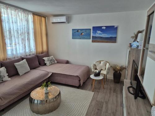 a living room with a couch and a table at Apartman Sanja in Ploče