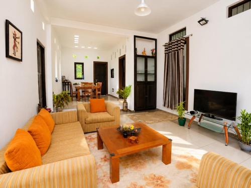 a living room with a couch and a table at Hilltop Retreat Matale in Matale