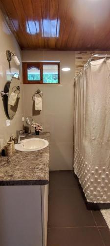 a bathroom with a sink and a shower at Villa Amaranto Oxapampa in Oxapampa