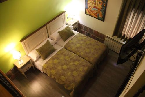 a bedroom with a large bed and two lamps at Douris Temple in Soria