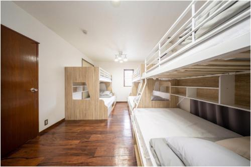 a room with two bunk beds and a hallway at en stay001 in Osaka