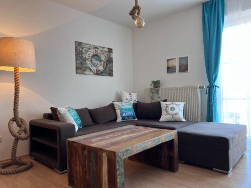 a living room with a couch and a coffee table at Lachmoewe in Orth