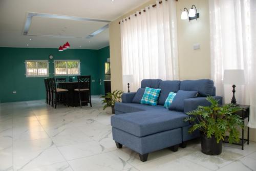 a living room with a blue couch and a table at Kai Dou in Roseau