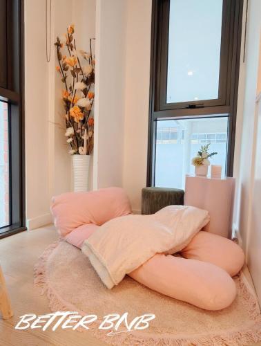 a room with two pillows sitting on a rug at Bloom Central – Pool & Gym in Wellington