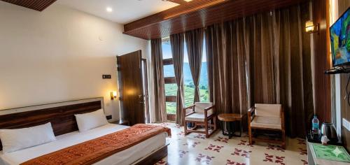 a hotel room with a bed and a large window at Salberry Hotel in Lansdowne