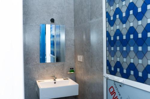 a bathroom with a sink and a mirror at Aathi Resort in Trincomalee