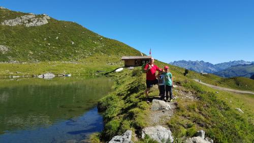 two people standing on a hill next to a river at Haus Silke in Silbertal
