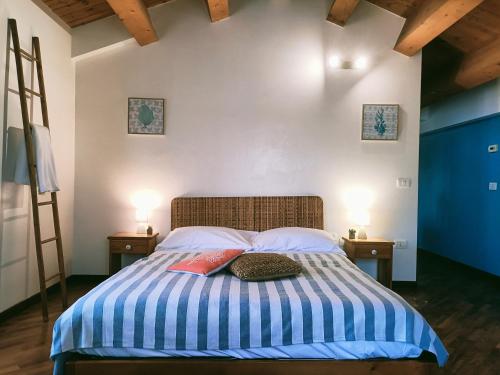a bedroom with a bed with two pillows on it at Ca' Le Erbe in Fano