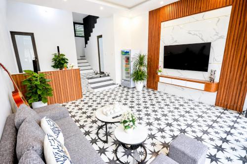 a living room with a couch and a tv at Sweet Apartment Sa Pa in Sapa