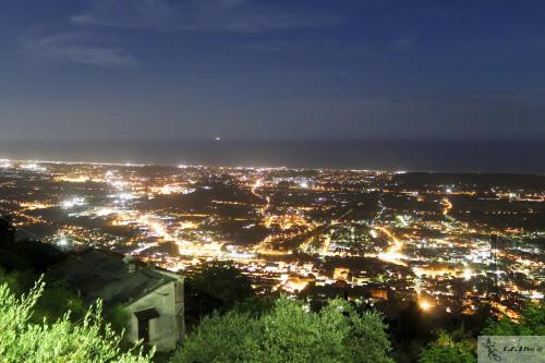 a view of a city lit up at night at Hotel Lungomare in Lido di Camaiore